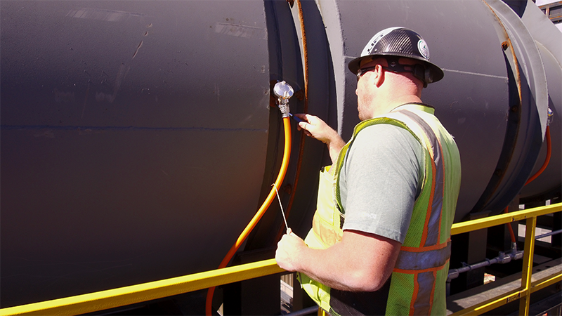 Worker Inspects Kiln During Service Visit